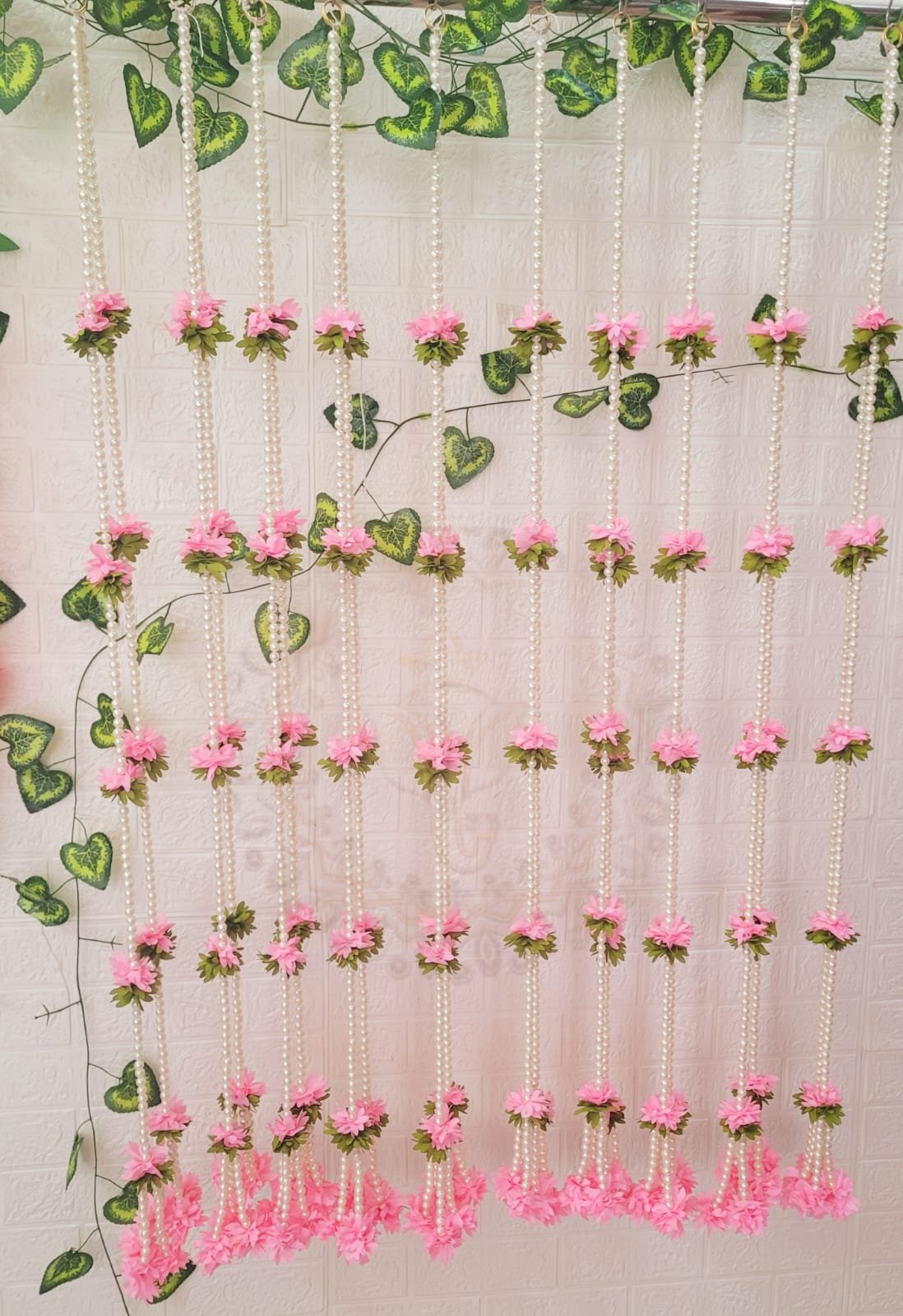 Pearl Gajra Hanging pack of 10 with pink flowers as wall backdrop – Kachi Rasoi
